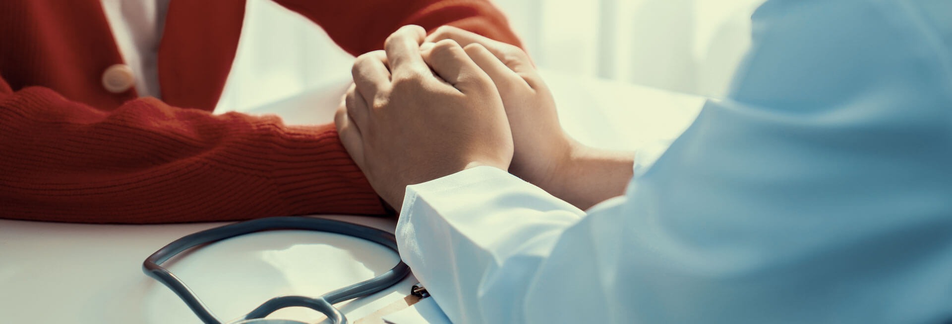 Doctor comforting patient by holding hands photo for Georgia Kidney Associates | Nephrologists | Nephrology Specialists